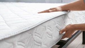 Woman's hands flipping white mattress